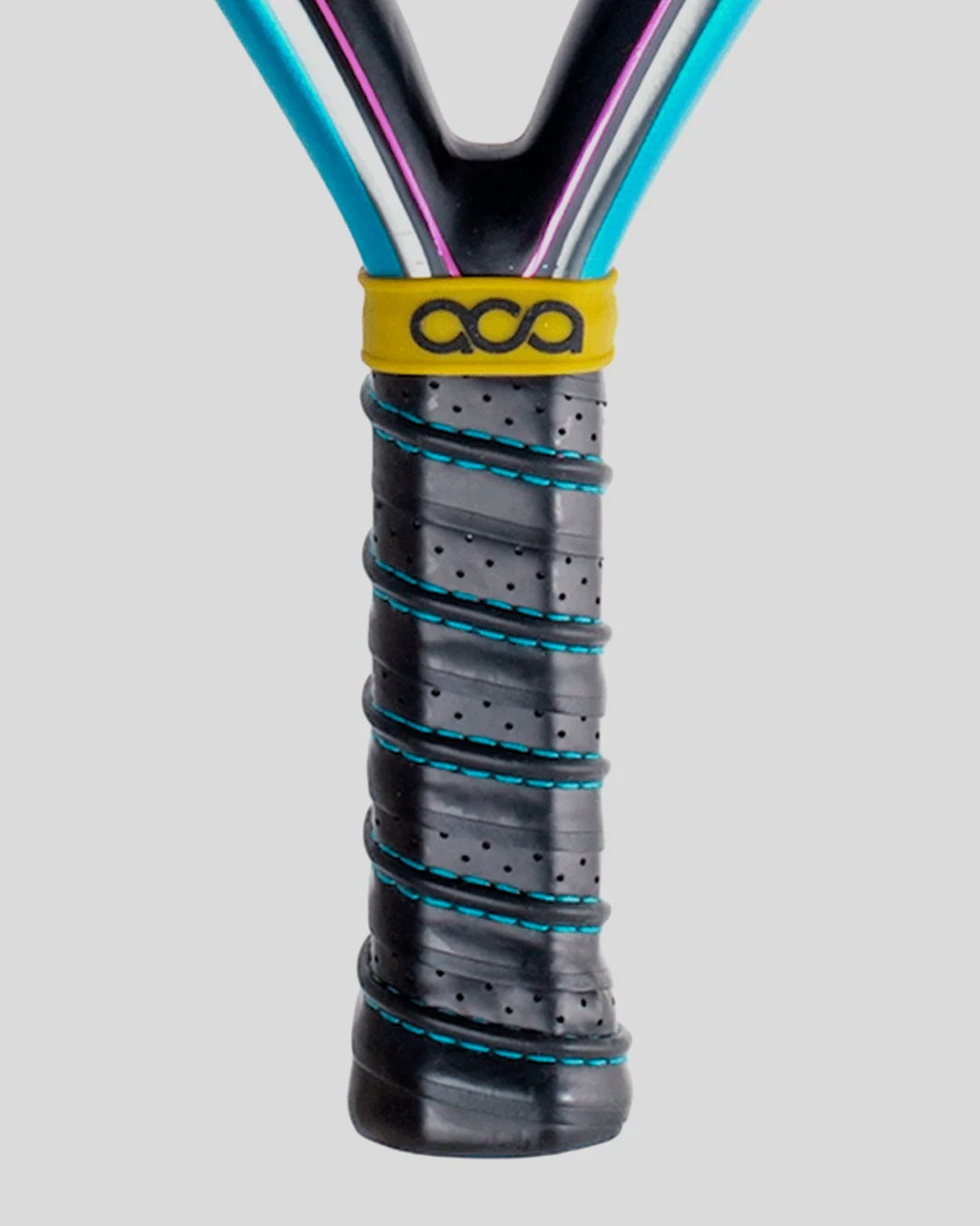 Close-up of a padel racket handle with a yellow ACA grip on a gray background