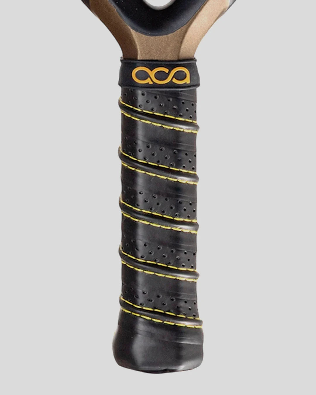 Close-up of a padel racket handle with black grip and yellow stitching on a gray background
